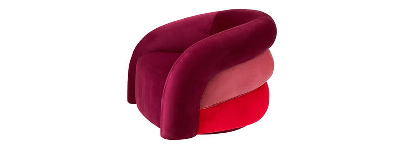 A velvet Eichholtz swivel chair with an ombre effect that goes from burgandy to cherry red